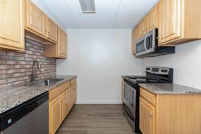 Saratoga Springs apartment for rent - a kitchen with wood cabinets and appliances and a counter top