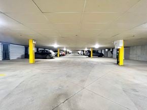 Regina apartment for rent - a parking garage with cars in it and yellow pillars