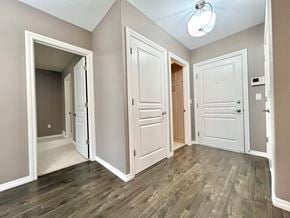 Regina apartment for rent - an empty living room with white doors and wood flooring