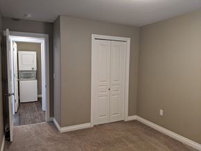 Regina apartment for rent - A white door is in a room with tan walls.