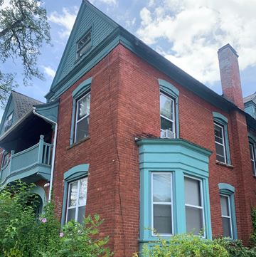 Ithaca apartment for rent - a brick house with blue trim and a blue roof