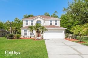 Orlando house for rent - a white house with palm trees in front of it