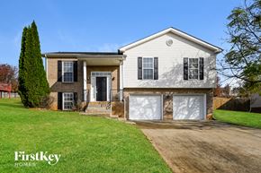 Clarksville house for rent - a white and brown house with black shutters and a driveway