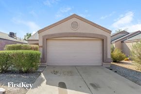 Phoenix house for rent - a home with a white garage door and a driveway