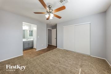 Phoenix house for rent - a living room with a ceiling fan and a carpet
