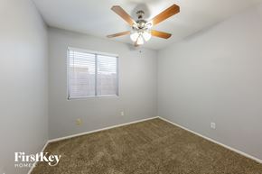 Phoenix house for rent - a bedroom with a ceiling fan and a window