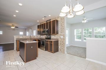 Greensboro house for rent - a large kitchen with stainless steel appliances and wooden cabinets
