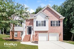 Colfax house for rent - a brick house with white siding and a white garage door