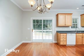 Colfax house for rent - a kitchen with wood floors and a door to a balcony