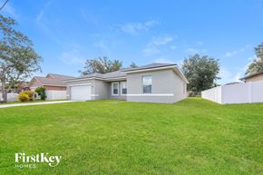 Poinciana house for rent - A house with a lawn in front of it is for sale by FirstKey Homes.