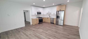 West Hollywood apartment for rent - A kitchen with wooden floors and white walls.