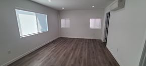 West Hollywood apartment for rent - A room with wooden floors and white walls.