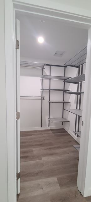 West Hollywood apartment for rent - A white door is open to a room with a white ceiling and a wall with shelves.
