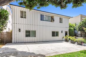 West Hollywood apartment for rent - A white building with a grey roof and a white fence.