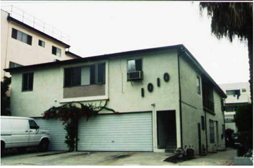 West Hollywood apartment for rent - A white van is parked in front of a garage door.