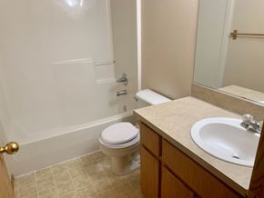 Kelso apartment for rent - A white toilet sits next to a sink in a bathroom.