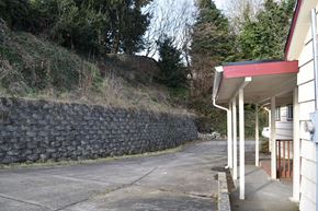 Kelso house for rent - a road next to a building and a stone wall
