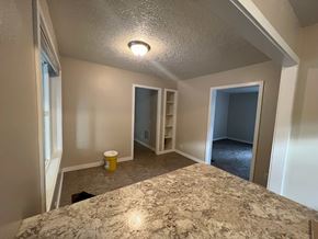 Kelso house for rent - a dining room with a marble counter top and a hallway with a closet
