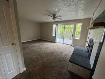 Kelso house for rent - a living room with a couch and a ceiling fan