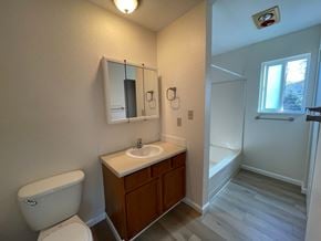 Kelso apartment for rent - A white toilet sits next to a sink in a small bathroom.