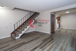 Longview apartment for rent - A room with a staircase and Rodman Realty Inc. written on the wall.
