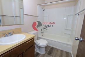 Longview apartment for rent - A bathroom with Rodman Realty Inc. logo on the wall.