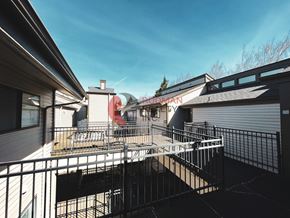 Longview apartment for rent - A balcony with a metal railing and a building with a sign that reads "HUDSON".