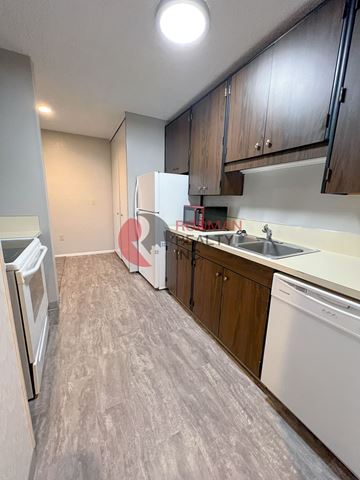 Longview apartment for rent - A kitchen with a white fridge and a white dishwasher.