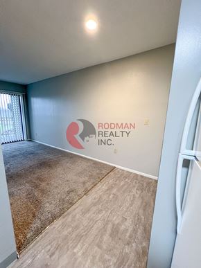 Longview apartment for rent - A room with Rodman Realty Inc. logo on the wall.