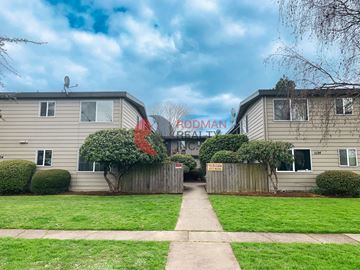 Longview apartment for rent - A residential area with two houses and a sign that says "Rodman Realty".