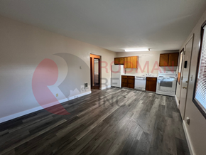 Longview apartment for rent - A room with wooden flooring and a white wall with a red circle on it.