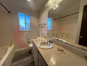 Longview apartment for rent - A bathroom with a tub, sink, and mirror.