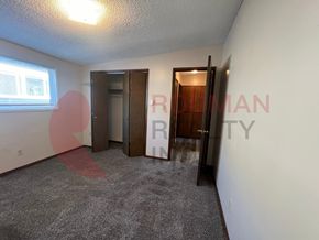 Longview apartment for rent - A room with a carpeted floor and two doors, one of which is open.
