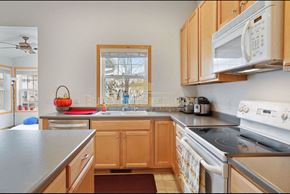 Plymouth house for rent - a kitchen with a stove and a sink and a window