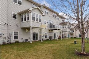 Plymouth house for rent - a view of the exterior of an apartment building with a lawn