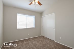 Tucson house for rent - a bedroom with a ceiling fan and a door to a closet