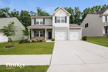 Charlotte house for rent - a white house with white shutters and a white driveway