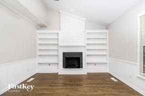 Greensboro house for rent - a living room with a fireplace and white shelves