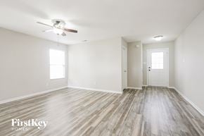 Camby house for rent - A spacious room with a wood floor and a ceiling fan.