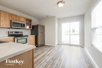 Camby house for rent - A kitchen with wooden cabinets and a stainless steel refrigerator.