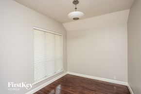 Crowley house for rent - a living room with a large window and wood floor