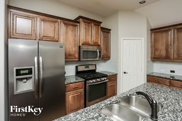 Crowley house for rent - an updated kitchen with stainless steel appliances and granite counter tops
