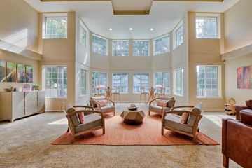 Olympia apartment for rent - a large living room with chairs and a table