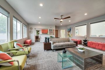 Olympia apartment for rent - a living room with furniture and a ceiling fan