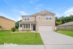 Jacksonville house for rent - a beige house with a sidewalk in front of it