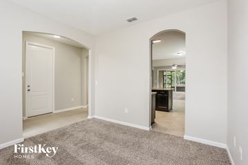 Jacksonville house for rent - a living room with a carpet and a door to a kitchen
