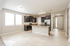 Jacksonville house for rent - a kitchen with black cabinets and a white counter top