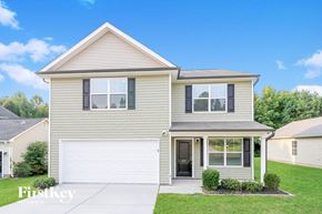 Winston Salem house for rent - a beige house with a white garage door