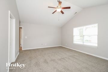 Winston Salem house for rent - a spacious living room with carpet and a ceiling fan