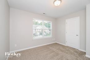 Winston Salem house for rent - a bedroom with a large window and a white door